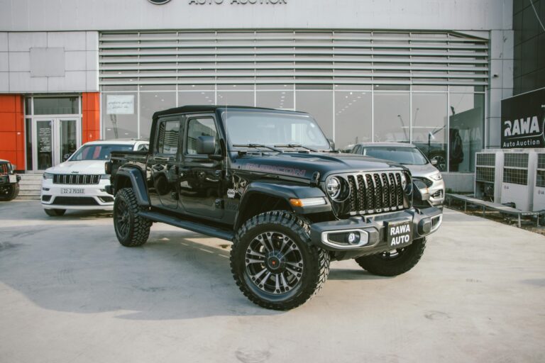 Black Jeep Gladiator Rubicon showcased outside RAWA Auto Auction dealership.